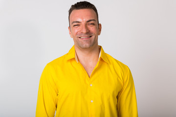 Fototapeta premium Portrait Of Man Wearing Yellow Shirt Against White Background
