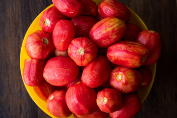 Whole Peeled Tomatoes in Yellow Bowl.