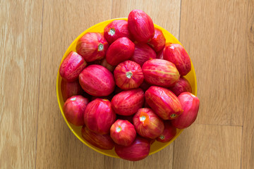 Whole Peeled Tomatoes in Yellow Bowl.
