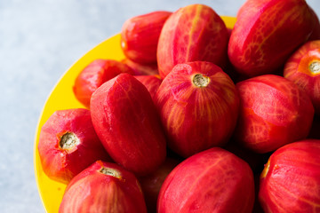 Whole Peeled Tomatoes in Yellow Bowl.