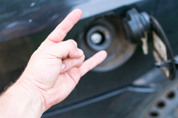 Excellent, good quality gasoline. View of the gas tank car and a positive gesture. Refilling the car.