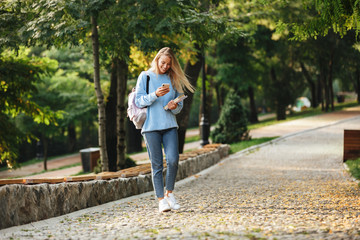 Portrait of a pretty young girl student with backpack