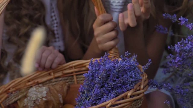 Summer picnic of children in lavender field in slow motion