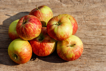 Fresh ripe apples on rustic wooden table