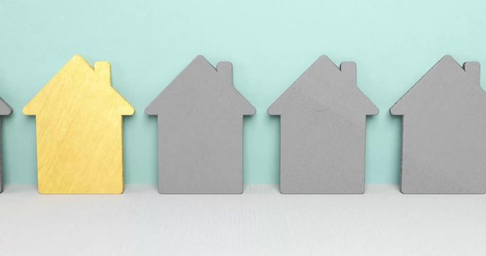 Haussuche. H&auml;user in einer Reihe. Ein goldenes Haus ist einzigartig und steht im Fokus.