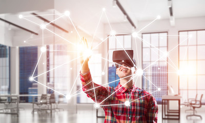 Guy wearing checked shirt and virtual mask reaching hand to touch screen