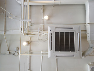 White Industrial air conditioner cooling pipe with plumbing at ceiling. Ventilation system ceiling air duct.