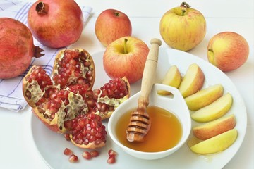 Apples dip in honey and pomegranate, Jewish New Year celebration.