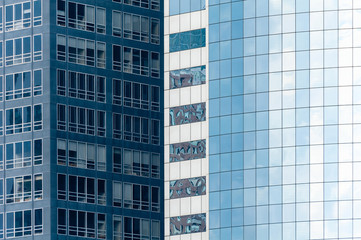 Skyscrapers from ground view with fogy sky visible.