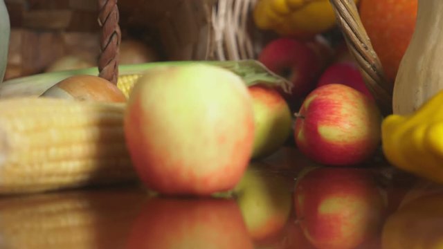 Autumnal Harvest or Thanksgiving, Cornucopia filled with vegetables, vegetables spilled out of the basket on the table. 4k, dolly shot