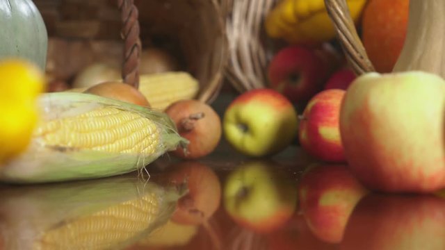 Autumnal Harvest or Thanksgiving, Cornucopia filled with vegetables, vegetables spilled out of the basket on the table. 4k, dolly shot
