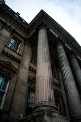 Naklejka premium An old building with columns in London, England on a cold day with a grey sky with clouds