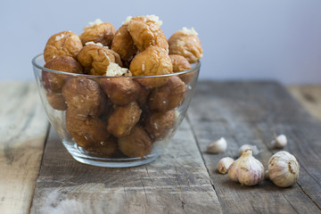 Donuts with garlic on a wooden background.