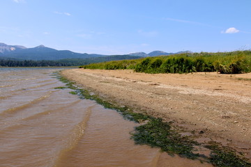 Deserted mountain lake beach