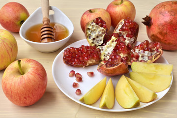 Ripe apples and pomegranate with honey, Jewish New Year celebration.