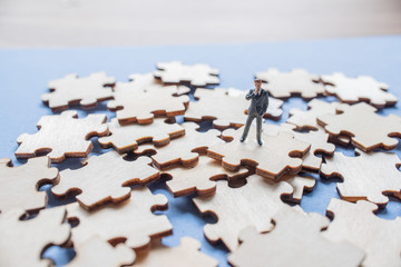 Miniature on wood jigsaw, Business concept