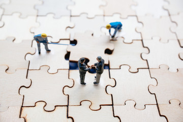 Miniature on wood jigsaw, Business concept