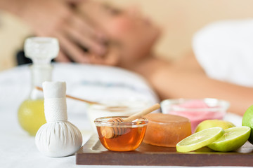 Young asian woman enjoying face massage in luxurious beauty salon.