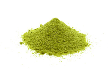 Powdered matcha green tea scattered on white background