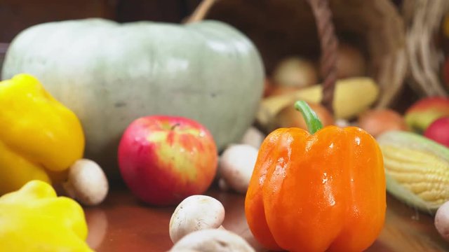 Autumnal Harvest or Thanksgiving, Cornucopia filled with vegetables, vegetables spilled out of the basket on the table. 4k, dolly shot