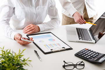 Business team two colleagues discussing new plan financial graph data on office table