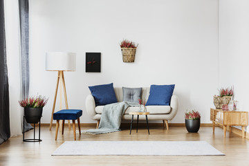 Sofa between lamp and cupboard