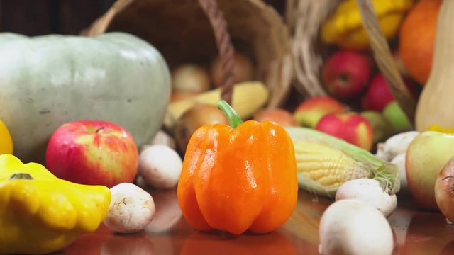 Autumnal Harvest or Thanksgiving, Cornucopia filled with vegetables, vegetables spilled out of the basket on the table. 4k, dolly shot