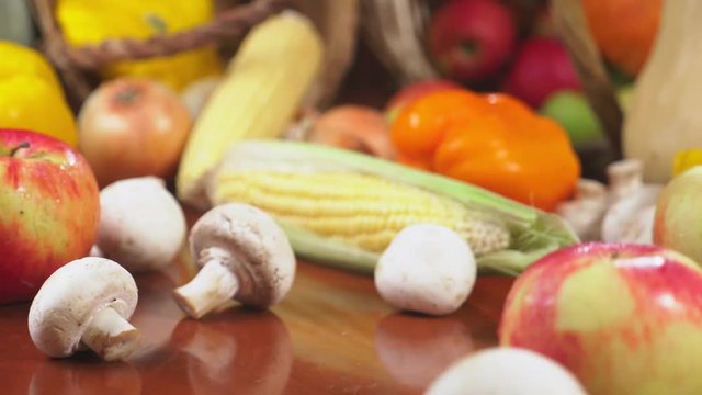 Autumnal Harvest or Thanksgiving, Cornucopia filled with vegetables, vegetables spilled out of the basket on the table. 4k, dolly shot