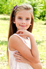 Fototapeta premium Portrait of adorable smiling little girl outdoors