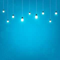 Blue background with hanging light bulb design for christmas