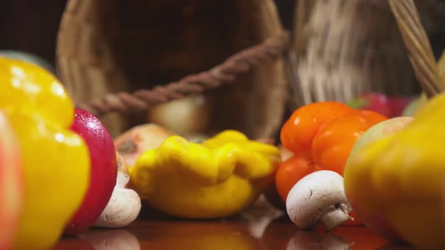 Autumnal Harvest or Thanksgiving, Cornucopia filled with vegetables, vegetables spilled out of the basket on the table. 4k, dolly shot