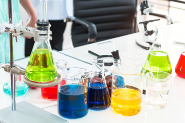 Color water in test tube and beaker.Copy space on white science lab.