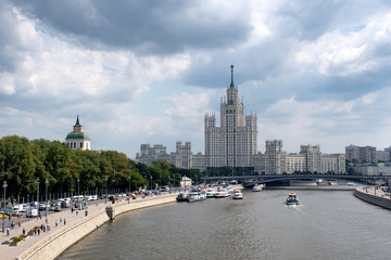 Fototapeta na wymiar City landscape with high-rise building, river and embankment. Moscow, Russia