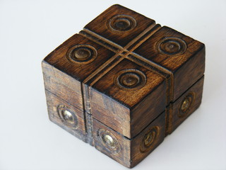 Wooden box with golden details over a white background.