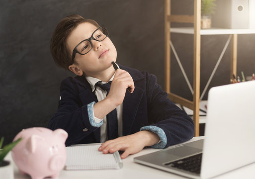 Little Boy In Suit Thinking About Finance