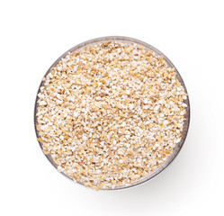Top view of bowl with barley grits isolated on white