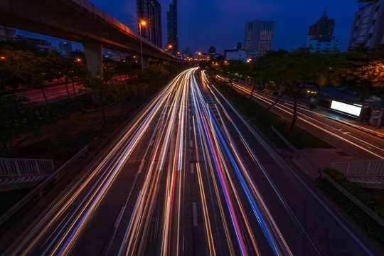 scenic of light tail of speed traffic with cityscape background
