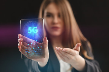 The concept of business, technology, the Internet and the network. A young entrepreneur working on a virtual screen of the future and sees the inscription: 5G