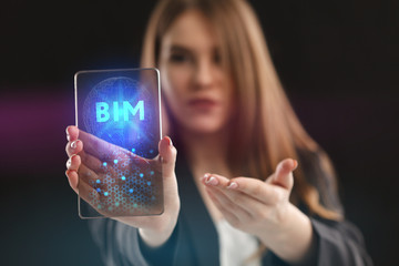 The concept of business, technology, the Internet and the network. A young entrepreneur working on a virtual screen of the future and sees the inscription: BIM