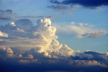 Dramatic cloudscape horizontal background with blue sky and colorful clouds