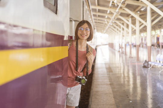 A lonely young woman travels her journey by train, at train station in Bankok,Thailand