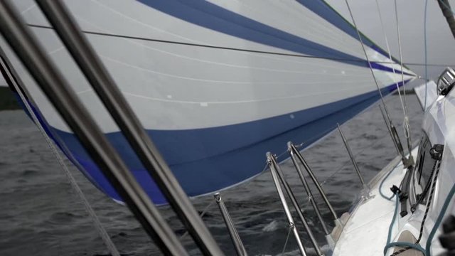 Deck of a white yacht with a blue rope in ocean. Sailing transportation for water sports. Regatta and the ocean as a lifestyle.