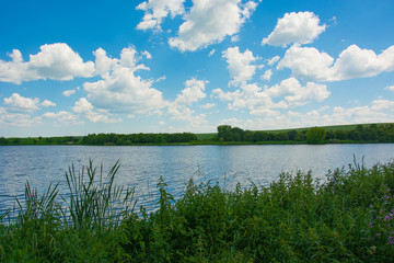 Beautiful blue sky with clouds above the lake