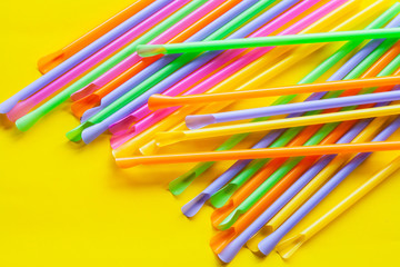 Colorful Straw on color background.