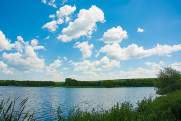 Beautiful blue sky with clouds above the lake