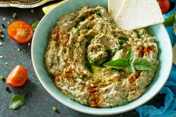 Arabic cuisine. Fresh homemade creamy mung hummus close-up on a stone or slate background. Ramadan food.