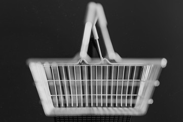 empty silver shopping basket on black