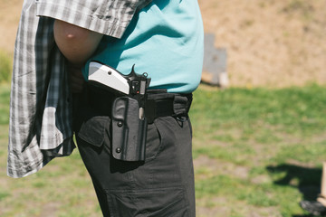 A man having a gun in holster no face