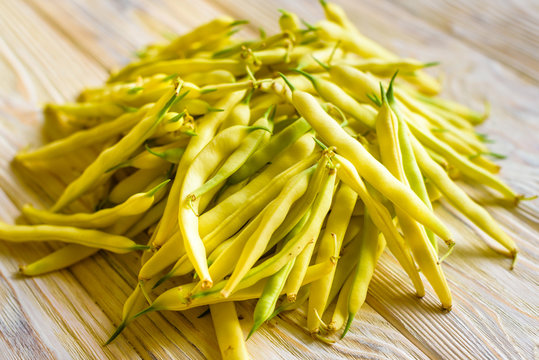 yellow beans on a wooden background top view.