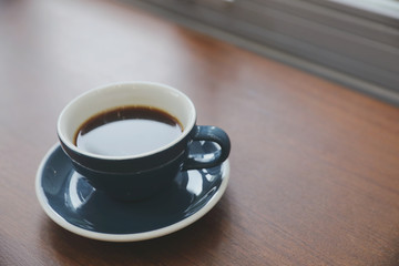 Black coffee in Coffee cup on wood background